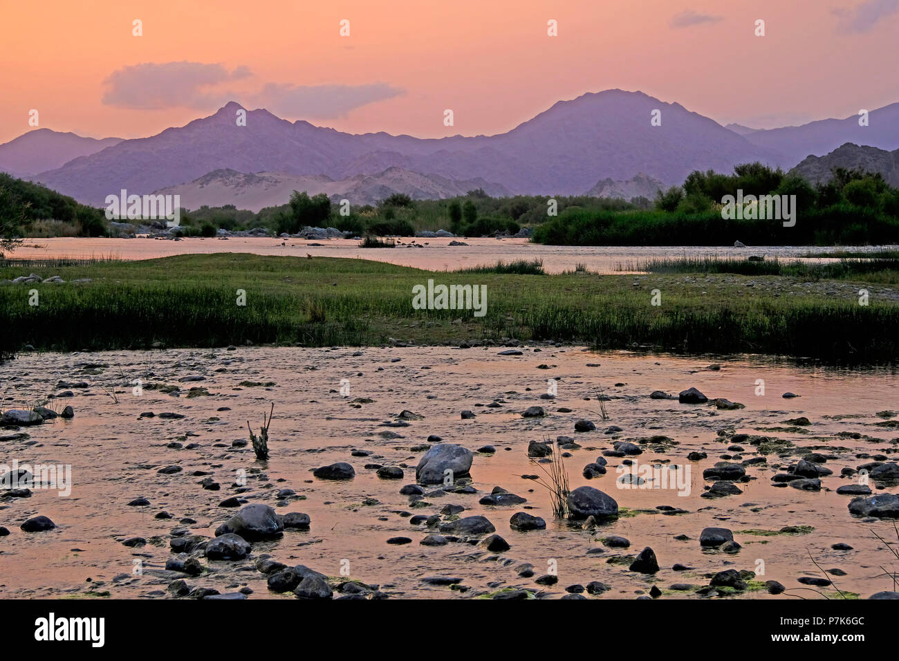 stony river bed of the Orange River / Oranjerivier (border river) in Richtersveld at evening mood, opposite side of Namibia, Namaqua, South Africa Stock Photo