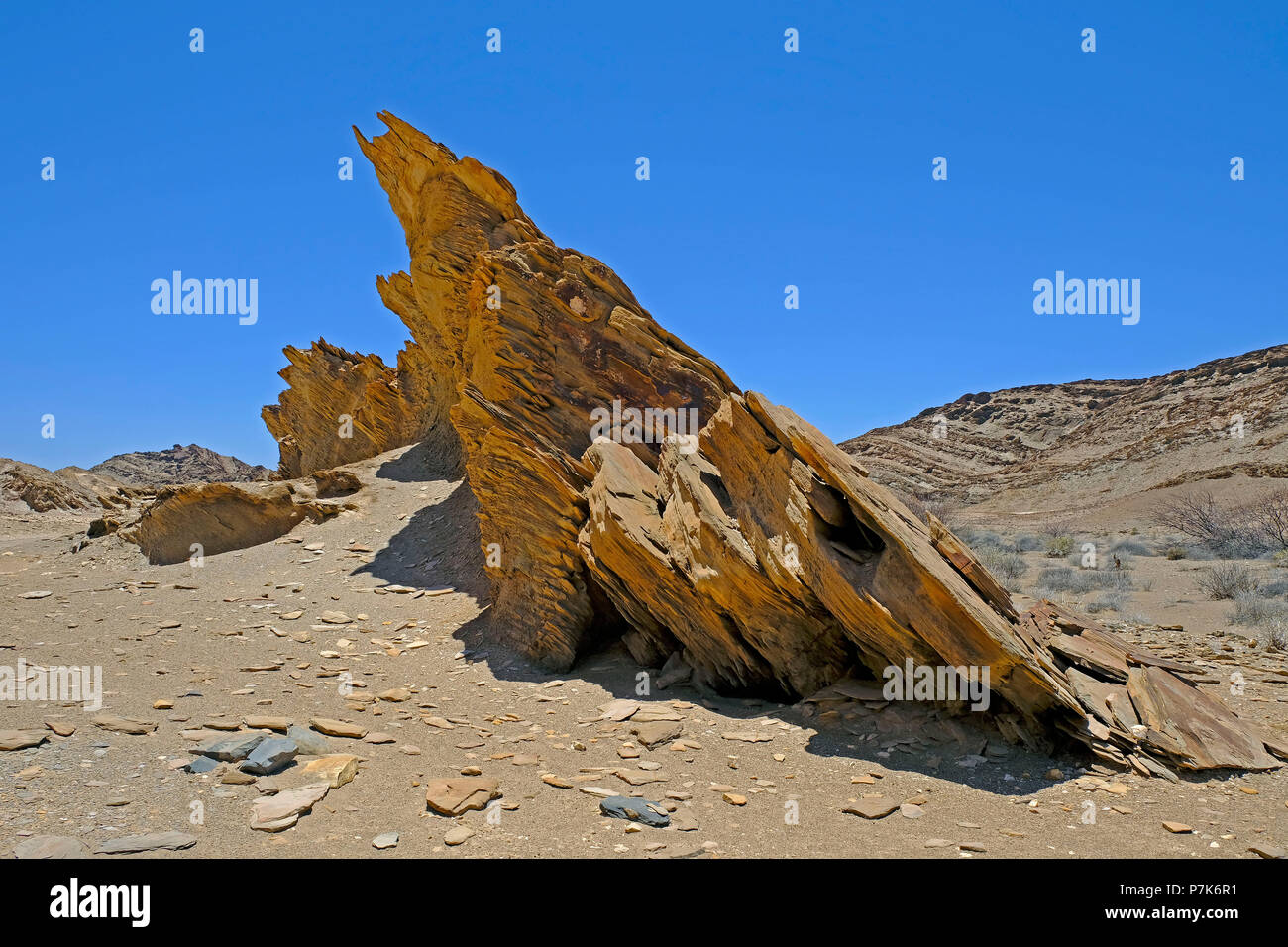 aslnat positioned, sharp-edged sediment plates in a dry river in the Brandberg-West area in Namibia Stock Photo