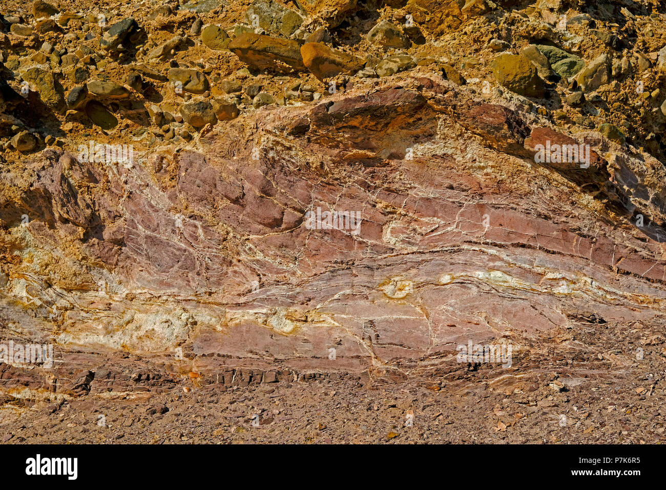 Detail of the washed-out, overhang terraces with coloured inclusions at the dry river Messum in the Dorob National Park in Namibia Stock Photo