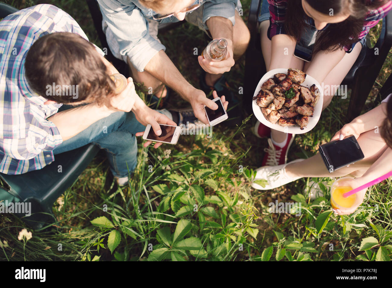 Group of friends having picnic in park Stock Photo - Alamy