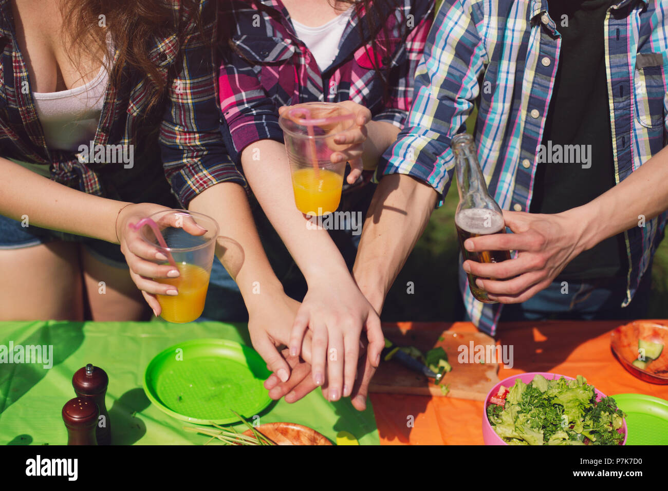 Group of friends having picnic in park Stock Photo - Alamy