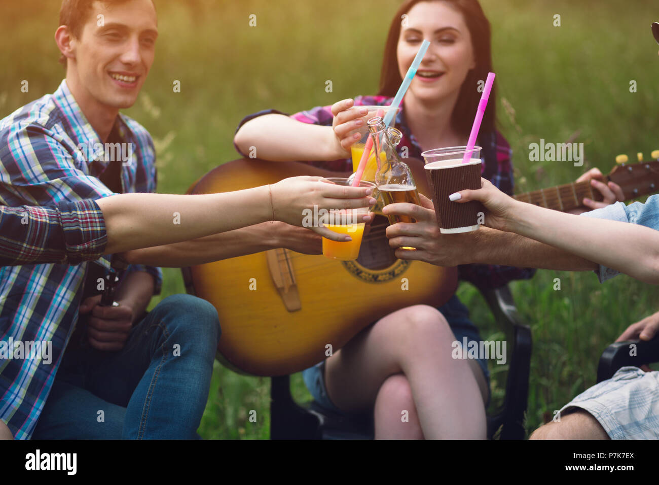 Group of friends having picnic in park Stock Photo - Alamy