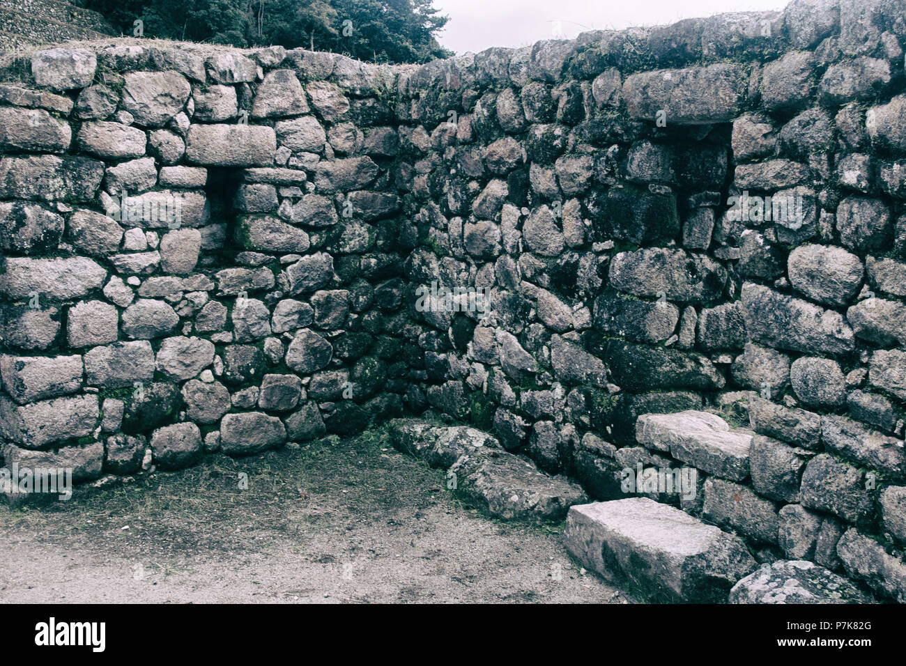 Stone magical ancient ruins along the paved path Inca Trail to Machu ...