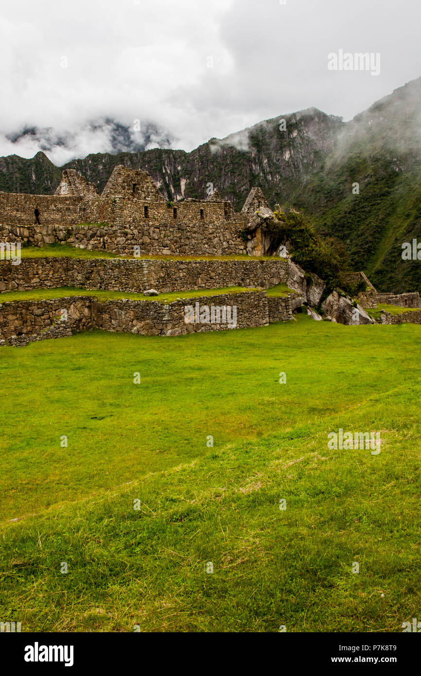 Vertical view of Machu Picchu stone ruins lost in the wild nature of ...