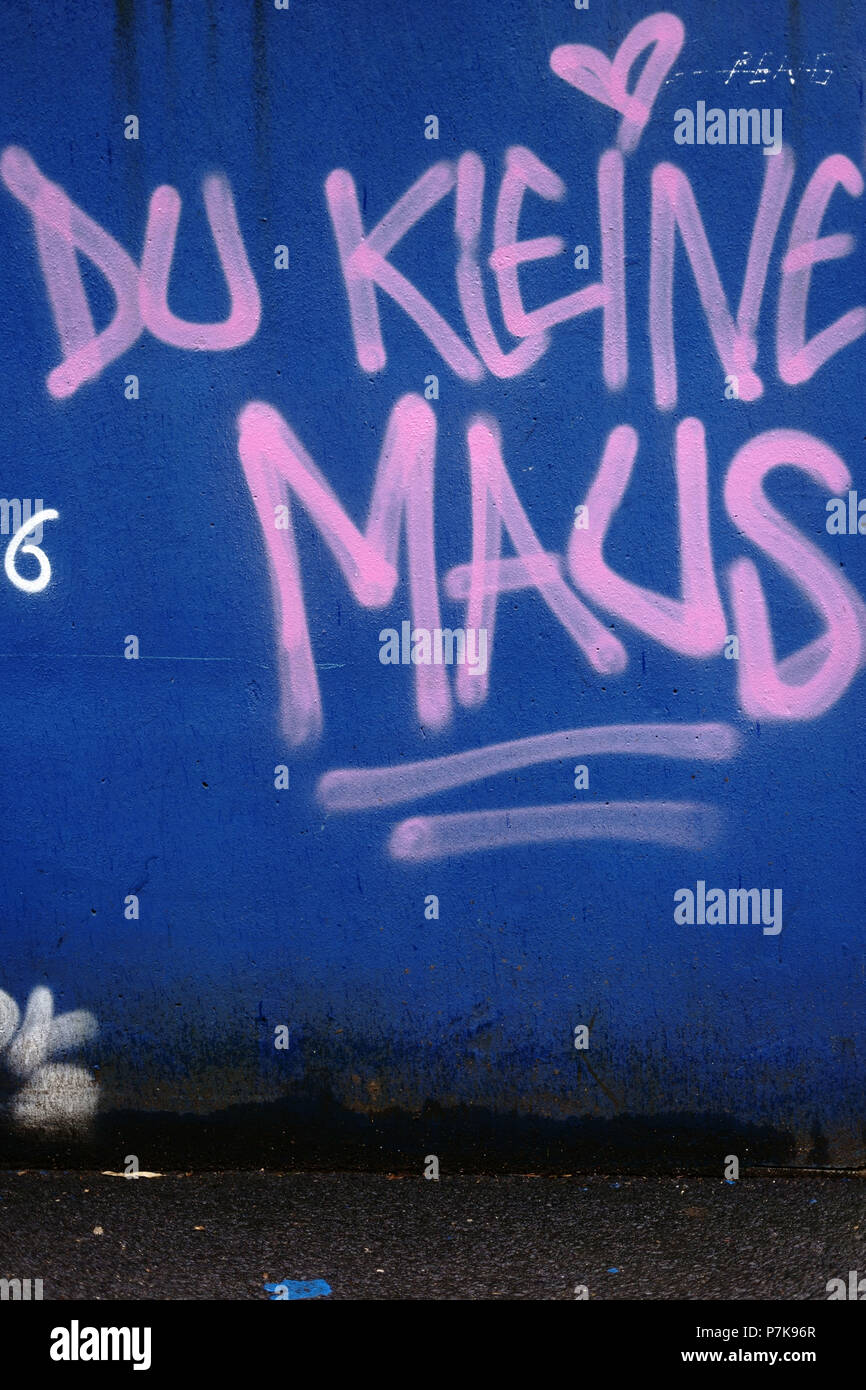 The slogan 'Du kleine Maus' on a blue wall with red letters, Stock Photo