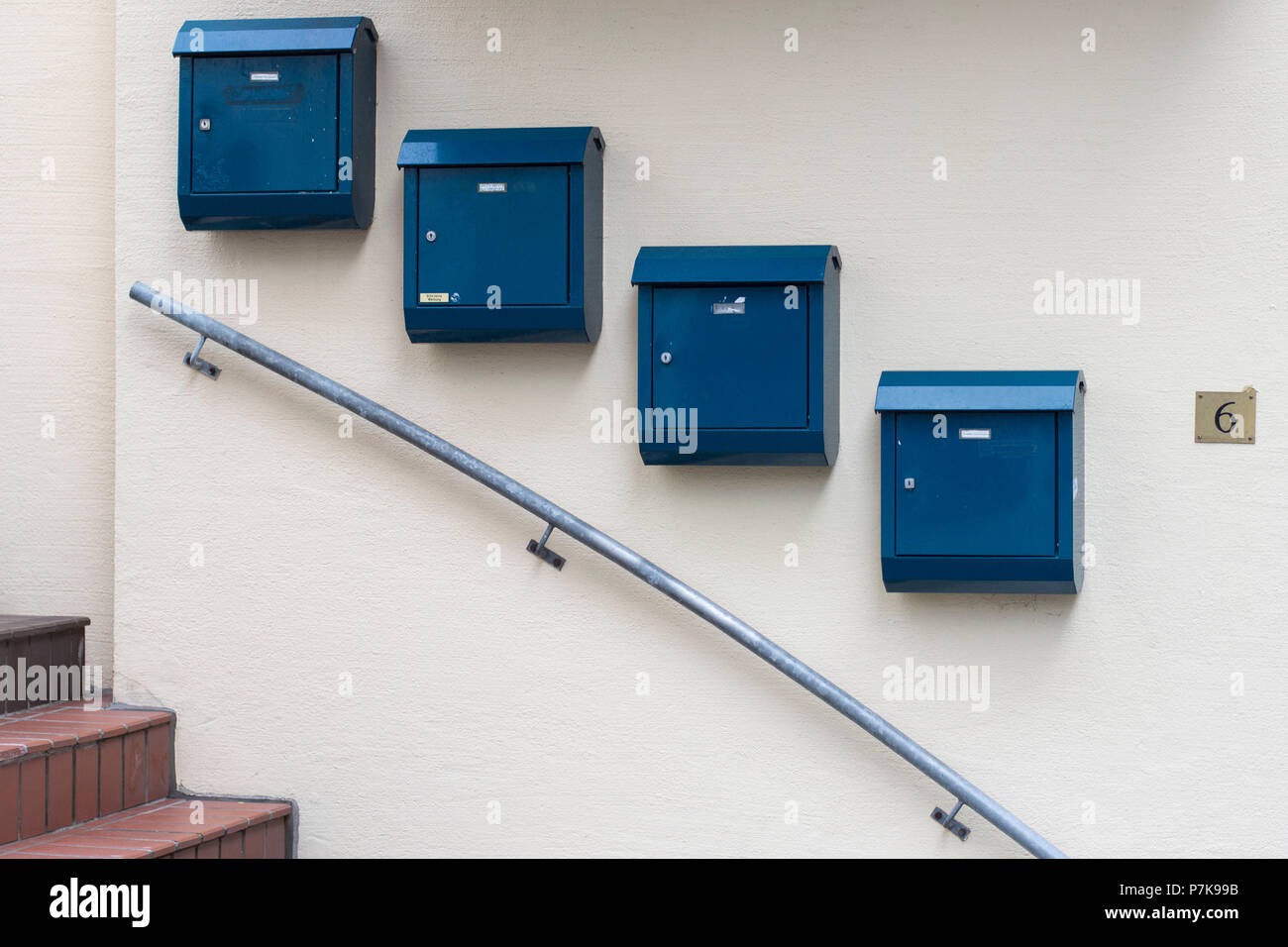 Blue mailboxes along a descending stair railing Stock Photo Alamy