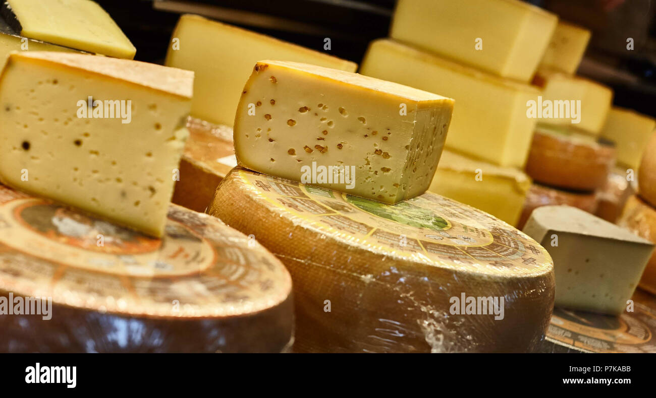 Cheese loaf, cheese wheel on bar counter, sales counter Stock Photo