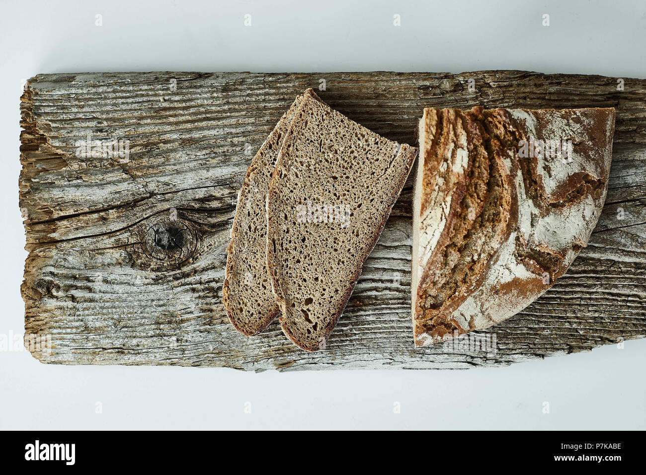 Bread on wooden board, perspective from above Stock Photo