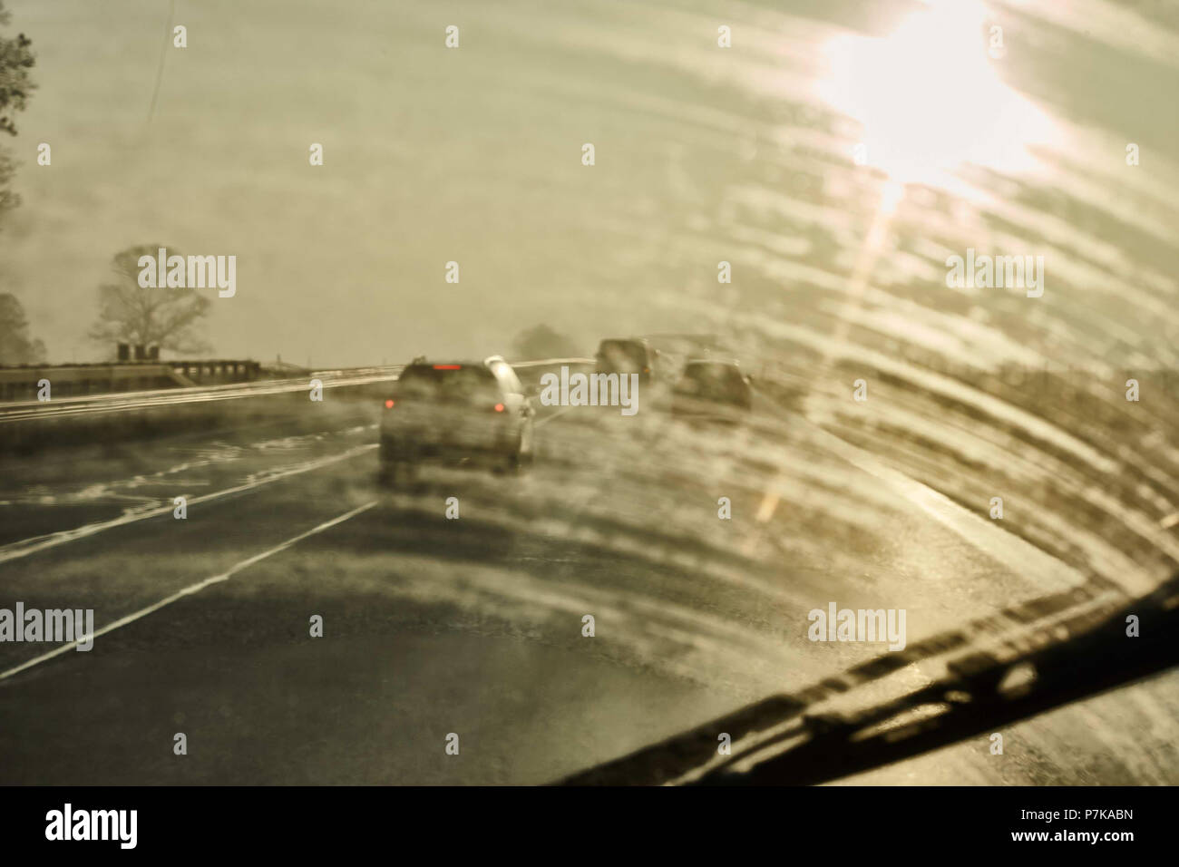 Highway, car, sunset, wet road, windshield wiper Stock Photo