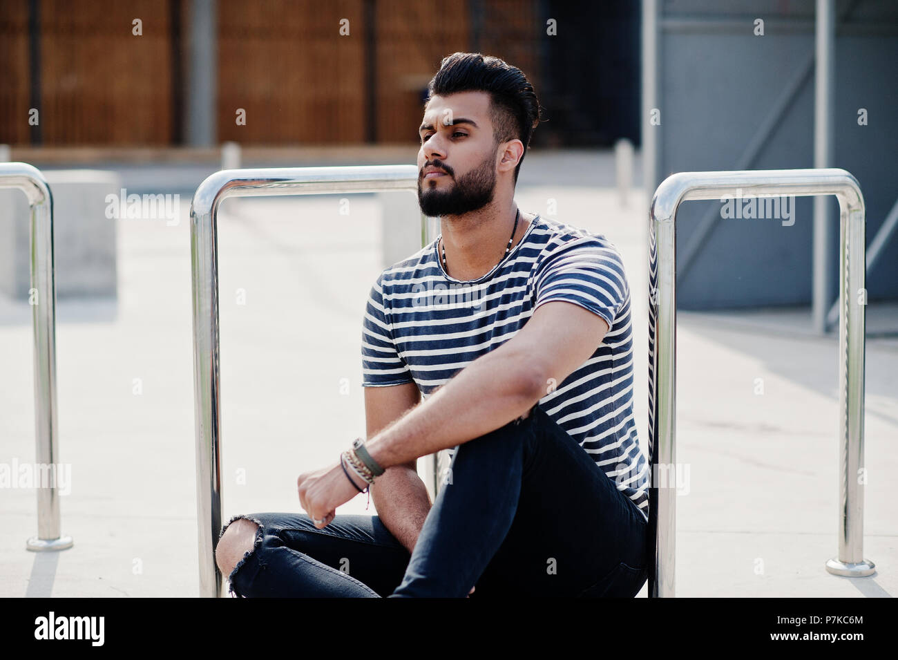 Handsome tall arabian beard man model at stripped shirt posed outdoor.  Fashionable arab guy Stock Photo - Alamy