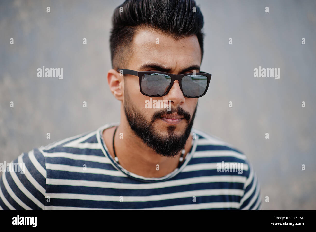 Handsome tall arabian beard man model at stripped shirt posed outdoor.  Fashionable arab guy at sunglasses Stock Photo - Alamy