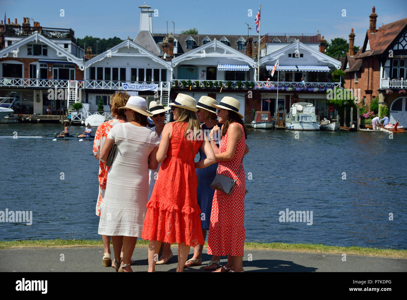 Henley Royal Regatta, Henley-on-Thames, UK. 6th July 2018. The third day of the Henley Royal Regatta took place on a stunning day in the Thames Valley.  Friends of the crew stand on the banks of the River Thames waiting for them to complete their race.Credit Wendy Johnson/Alamy Live News Stock Photo