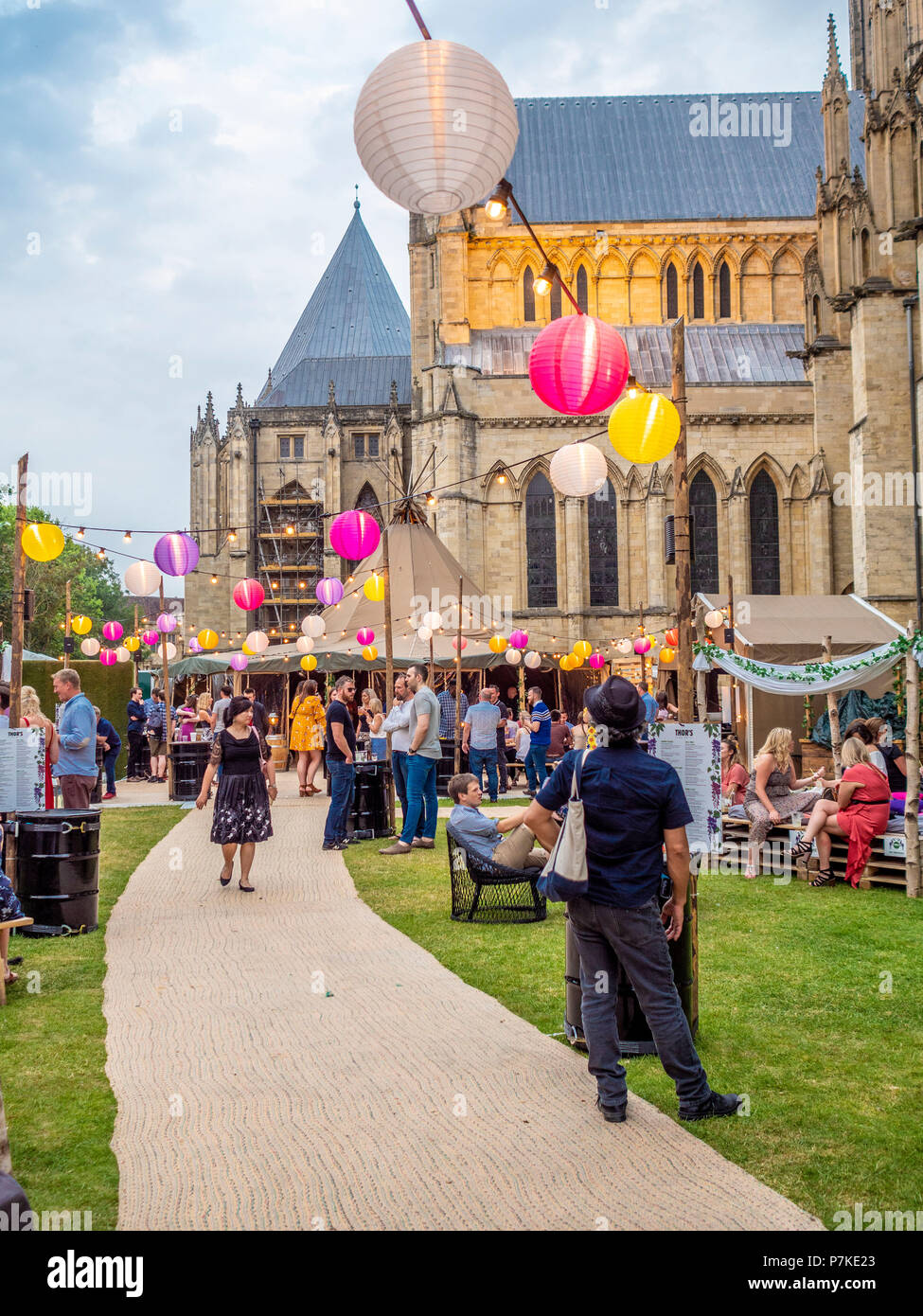 York, UK. 6th July 2018. SÓL ÁST – the pop-up bar with a summery vibe – begins a two month residency in the shadows of York Minster. Two linked canvas tipis adorned with greenery and lanterns form the unique venue, combining indoor cosiness with a unique summer theme set against one of the world’s most spectacular gothic backdrops. The event is part of the “Summer in the Park: Heart of Yorkshire” festival that is being hosted the Dean’s Park by York Minster throughout the summer. Credit: Bailey-Cooper Photography/Alamy Live News Stock Photo