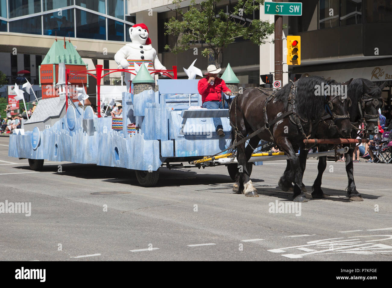 Calgary, Canada. 6th July, 2018.  Carnaval de Quebec float is pulled by a team of draft horses in the Calgary Stampede Parade. The parade through downtown kicks off the Calgary Stampede each year. Rosanne Tackaberry/Alamy Live News Stock Photo
