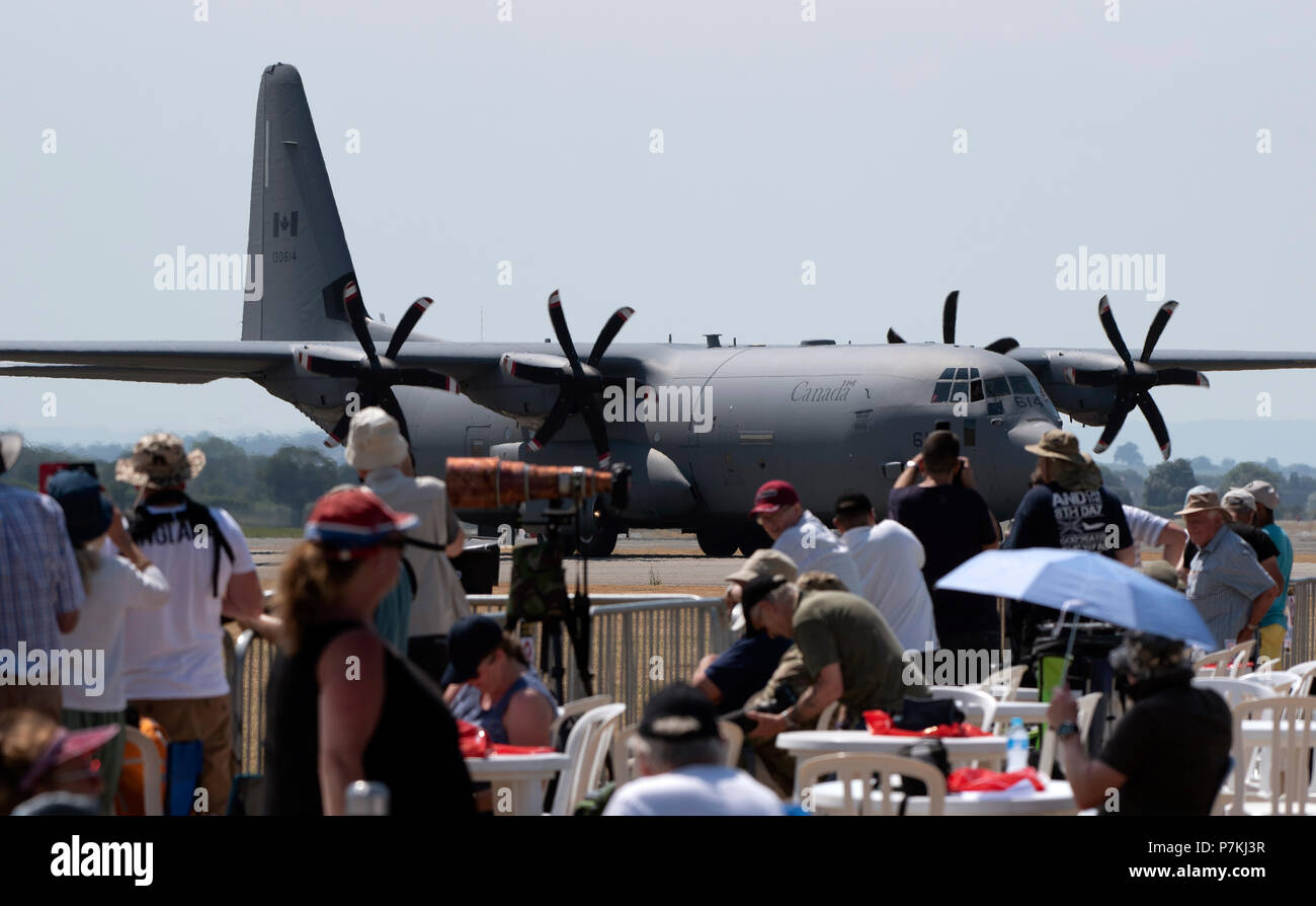Yeovilton Royal Naval Air Station, Somerset, UK. . Spectators watch the arrival of a Canadian airforce Lockheed C 130 Hercules aircraft Stock Photo
