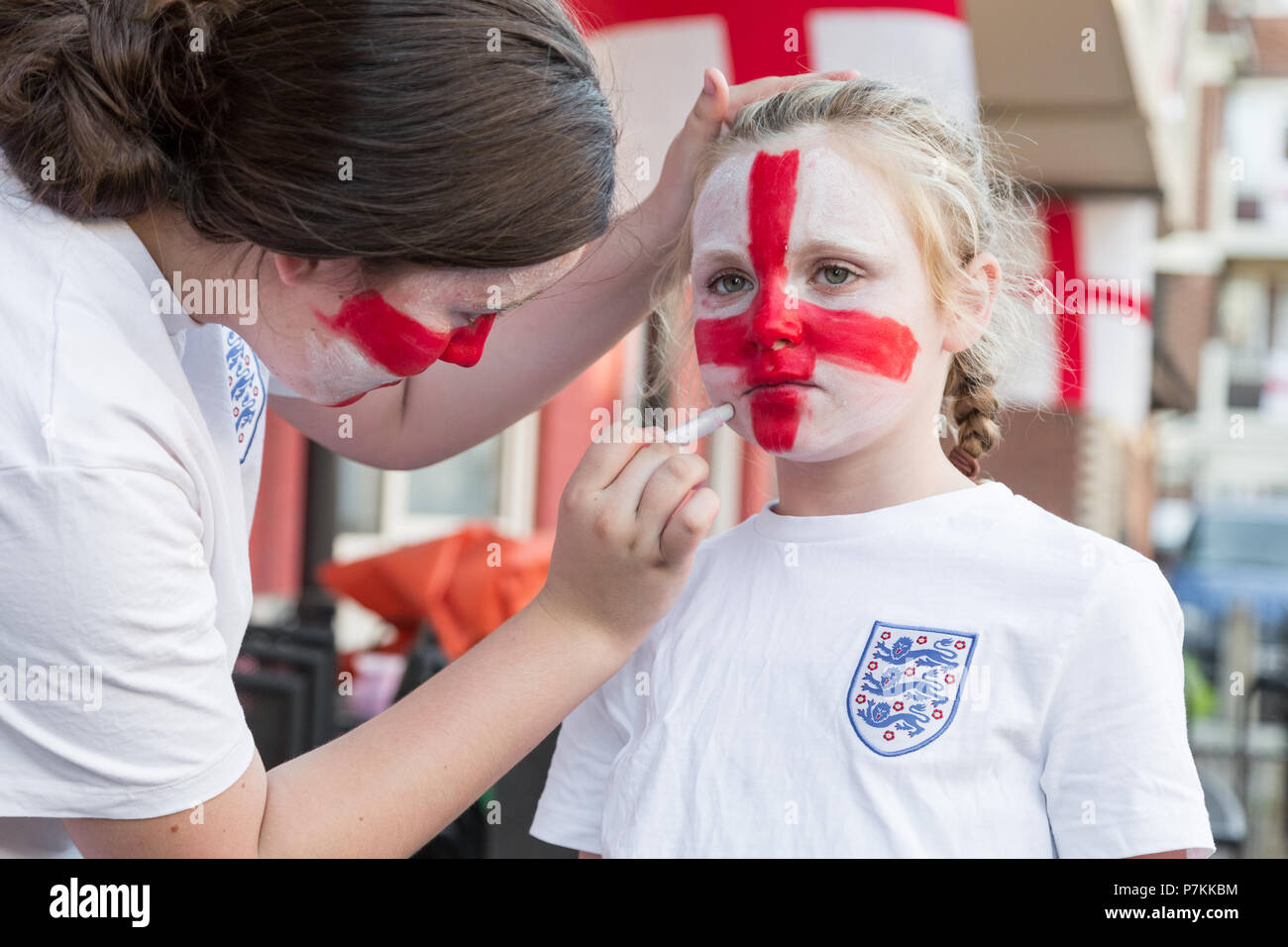 Young England fans from the Kirby Estate in Bermondsey get face painted with Flag of England colours ready for the FIFA World Cup 2018 Stock Photo