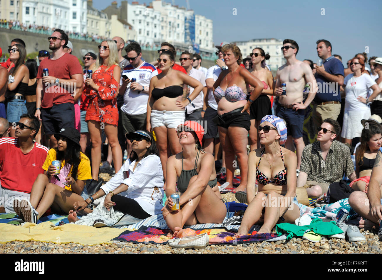 Brighton UK 7th July 2018  - England fans celebrate beating Sweden 2-0 as they watch a giant screen on Brighton beach showing the World Cup Quarter Final football match between England and Sweden today Credit: Simon Dack/Alamy Live News Stock Photo