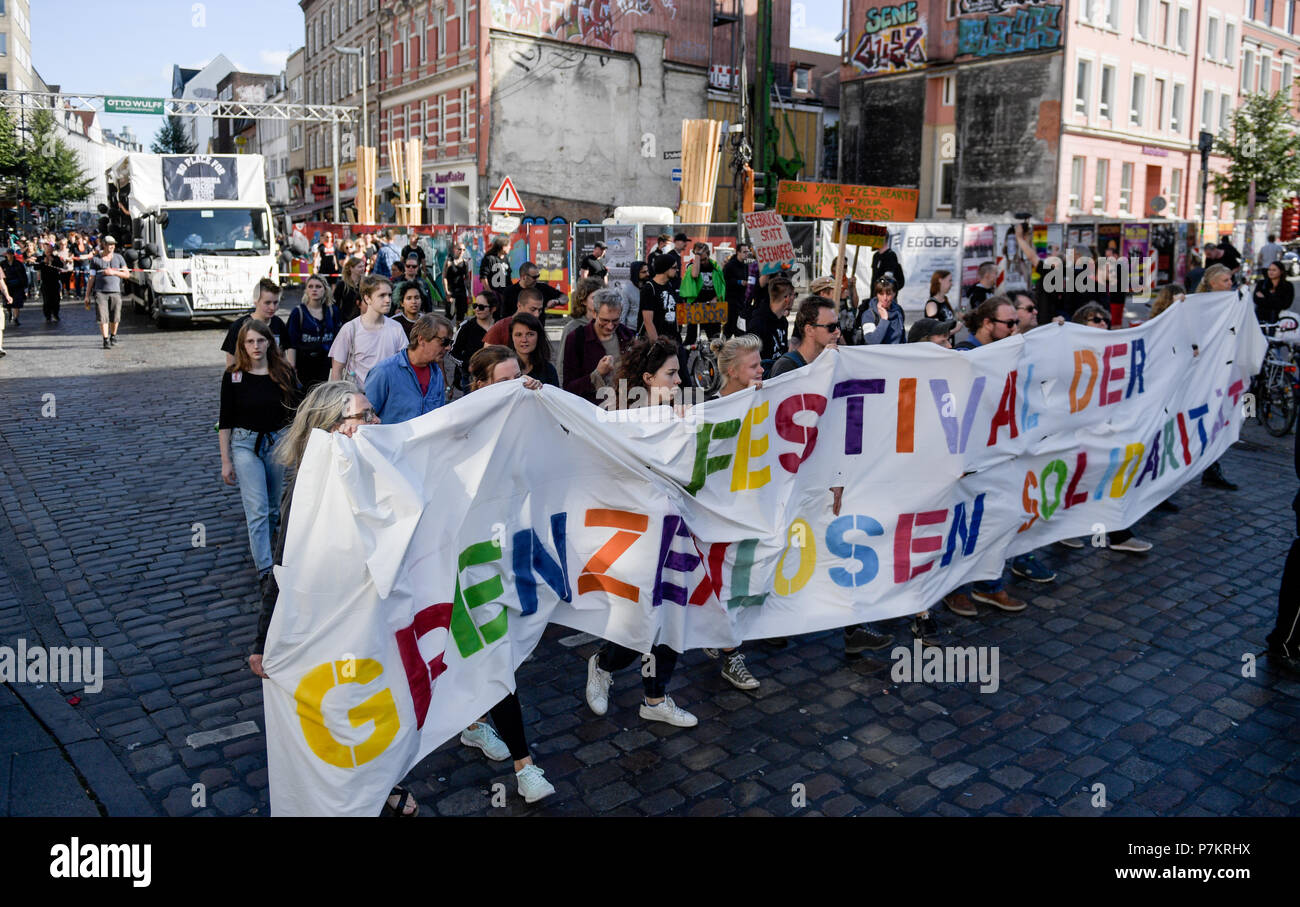 Hamburg, Germany. 07th July, 2018. Protesters take to the streets one year after the G20 summit. The demonstration runs under the slogan 'Solidarity without borders instead of G20'. Credit: Axel Heimken/dpa/Alamy Live News Stock Photo