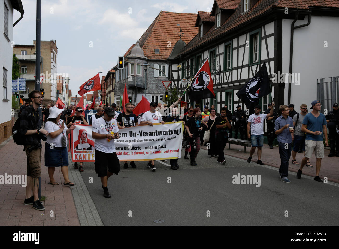 Kandel, Germany. 7th July 2018. Counter protesters march through Kandel. Around 200 people from right-wing organisations protested for the 10. time in the city of Kandel in Palatinate against refugees, foreigners and the German government. They called for more security of Germans and women from the alleged increased violence by refugees. Credit: Michael Debets/Alamy Live News Stock Photo