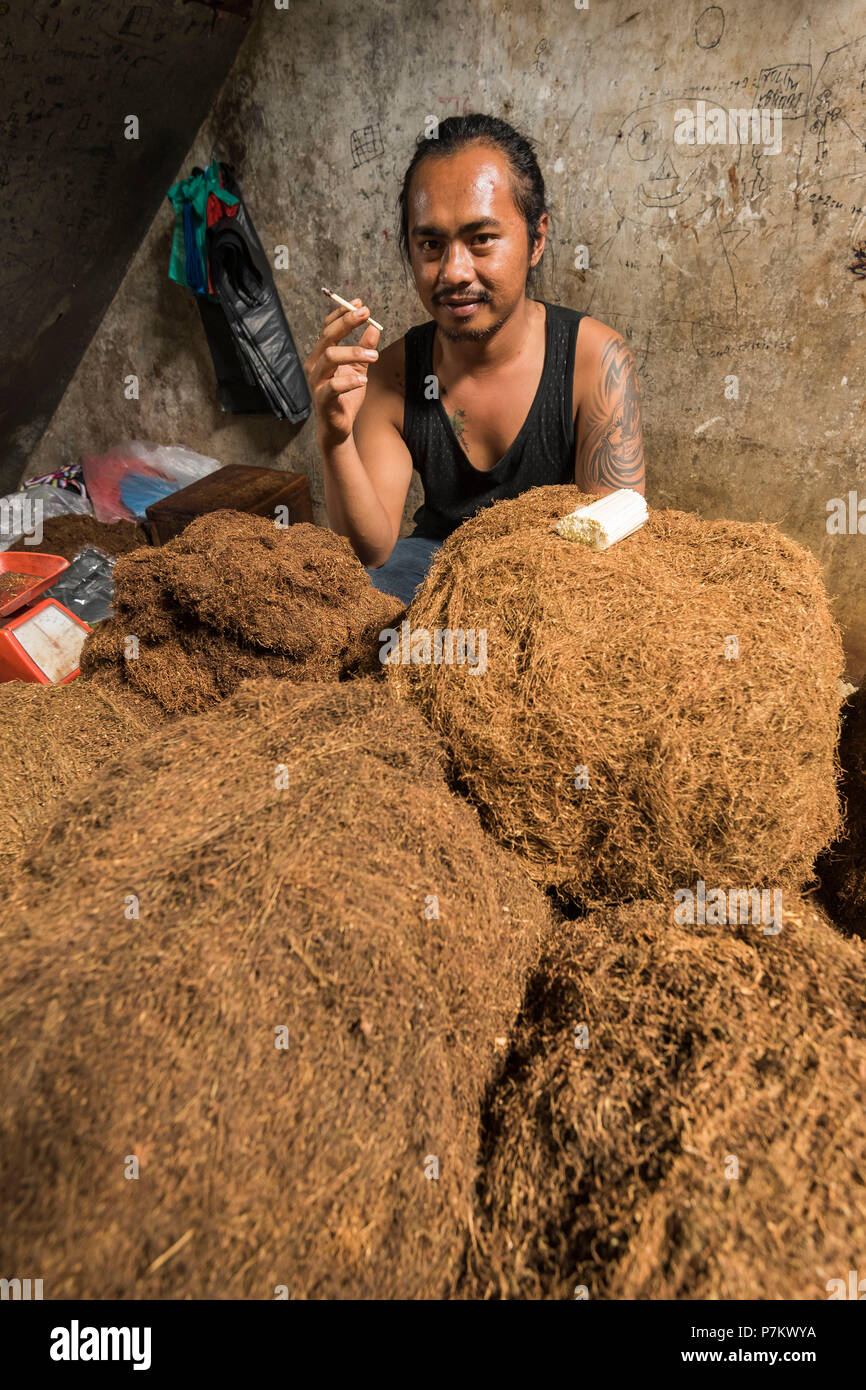 tobacco intoxication The tobacconist of Kutacane smoking behind his tobacco Stock Photo