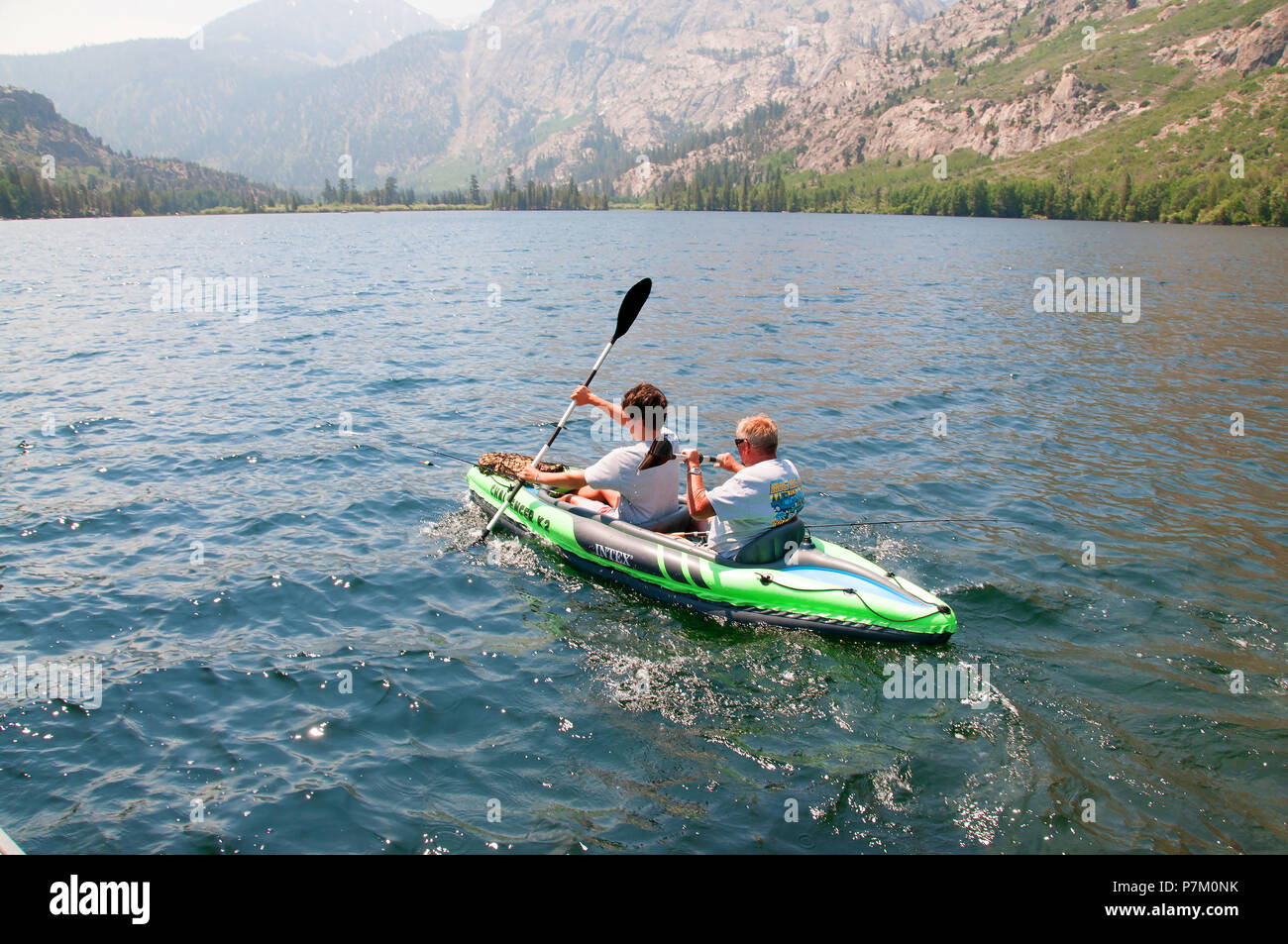 Kayakers explore beautiful Silver Lake in the June Lake Loop. It offers good fishing for rainbow trout. Stock Photo