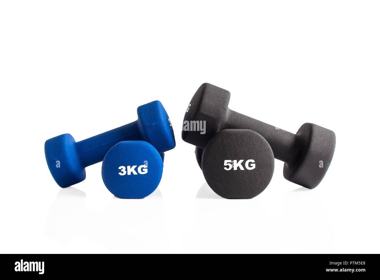 3kg and 5kg gym dumbbells isolated on a white background. Stock Photo