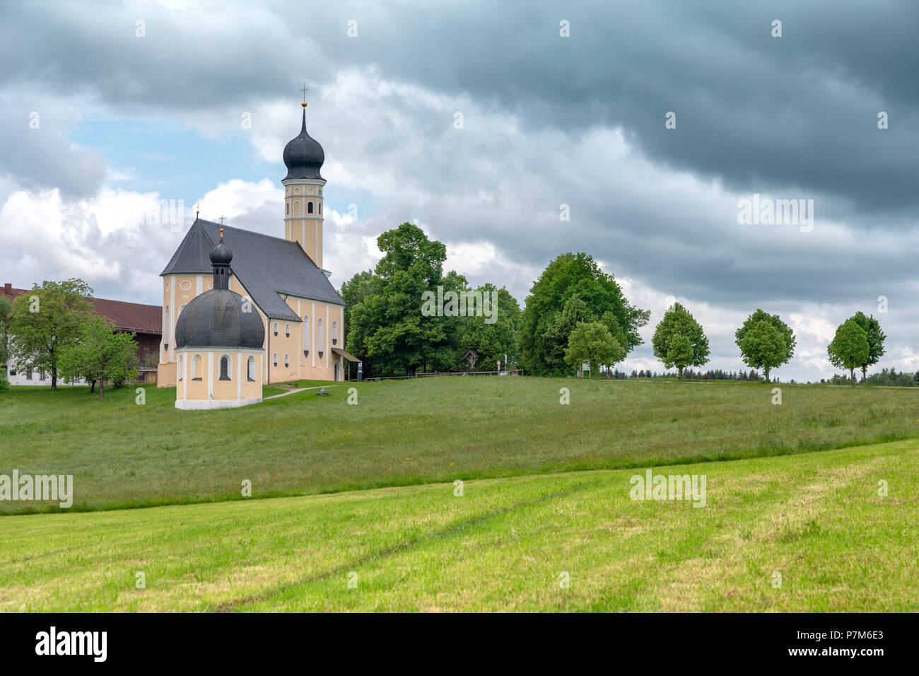 Wilparting Pilgrimage Church with green meadows and trees on a sunny day in springtime, Irschenberg, Upper Bavaria, Germany Stock Photo