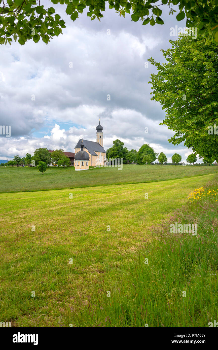 Wilparting Pilgrimage Church with green meadows and trees on a sunny day in springtime, Irschenberg, Upper Bavaria, Germany Stock Photo