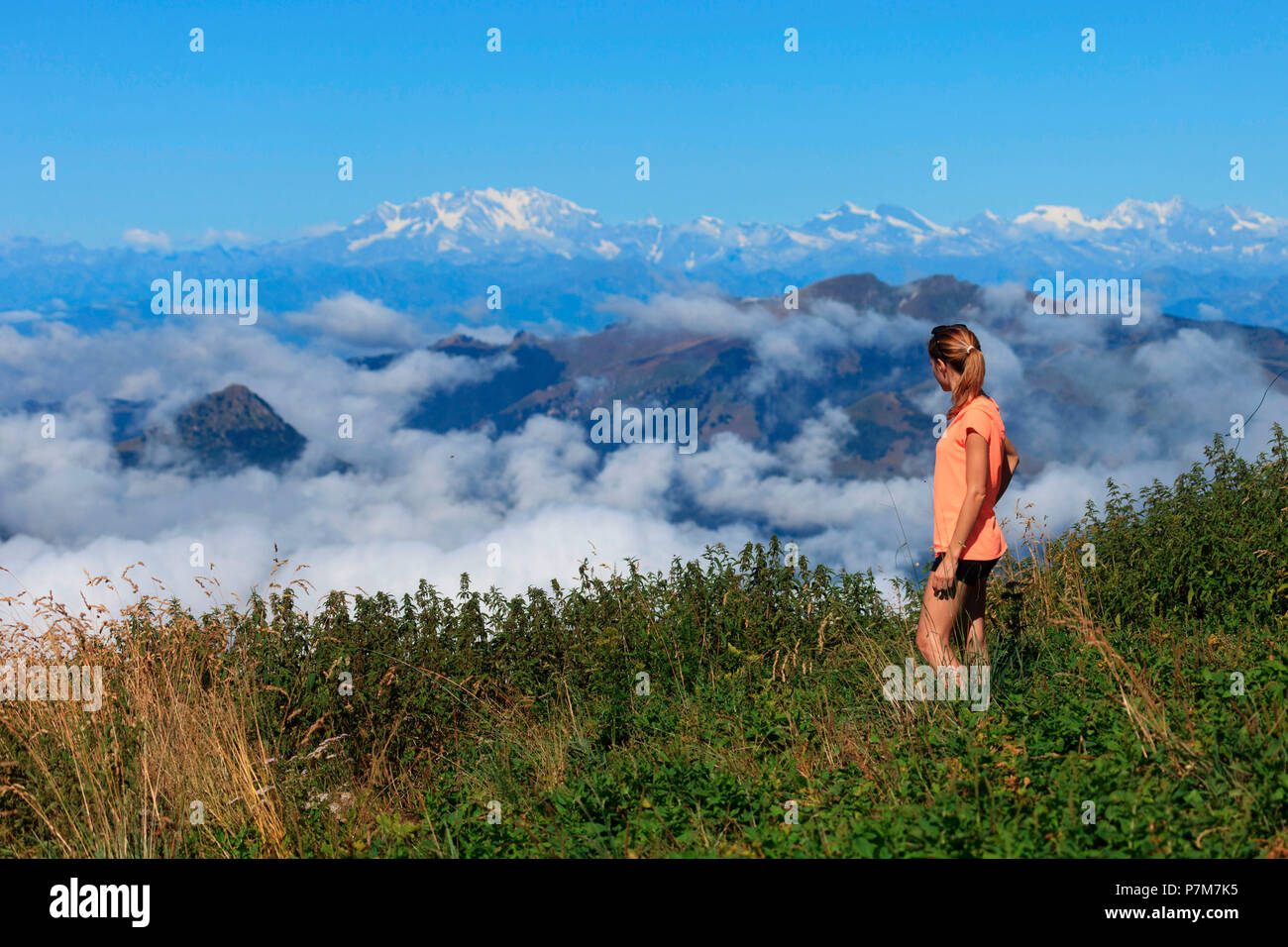 Hiker on the path leading to the summit of Monte San Primo looking at Monte Rosa, Triangolo Lariano, Bellagio, Province of Como, Lombardy, Italy Stock Photo