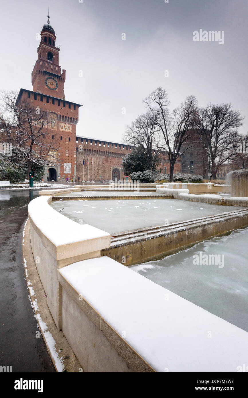 A iced fountain and Sforzesco Castle after a snowfall, Milan, Lombardy, Northern Italy, Italy, Stock Photo