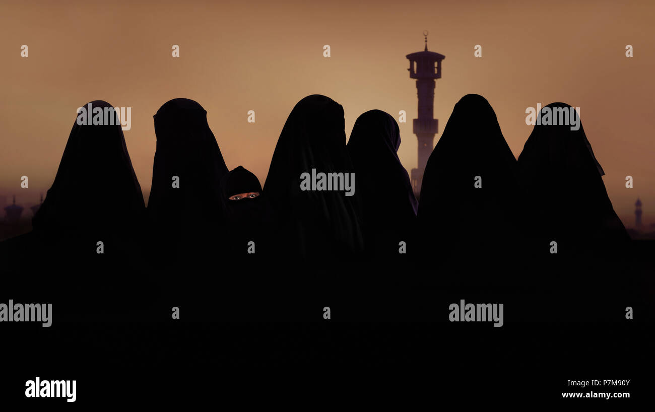 Silhouette of muslim women and girl in muslim attire, burqa Stock Photo