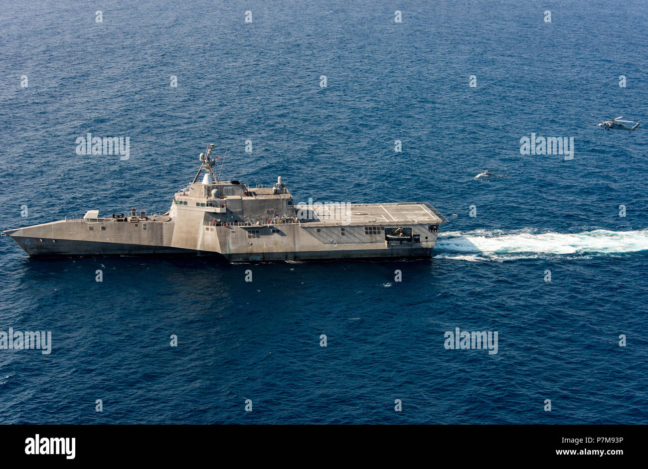 180628-N-BT947-1540  PACIFIC OCEAN (June 28, 2018) - An MQ-8C Fire Scout unmanned helicopter conducts underway operations with an MH-60S Seahawk helicopter and the Independence-variant littoral combat ship USS Coronado (LCS 4). The new Fire Scout variant is expected to deploy with the LCS class to provide reconnaissance, situational awareness, and precision targeting support. Coronado is working with Air Test and Evaluation Squadron 1 (VX-1) to test the newest Fire Scout unmanned helicopter. Coronado is one of four designated test ships in the LCS class assigned to Littoral Combat Ship Squadro Stock Photo