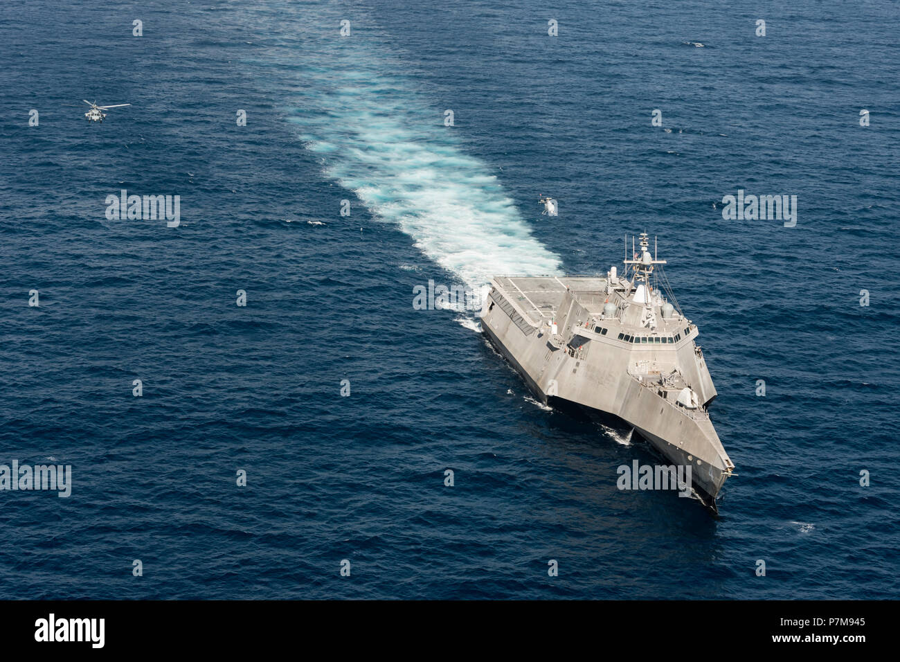 180628-N-BT947-1567 PACIFIC OCEAN (June 28, 2018) - An MQ-8C Fire Scout unmanned helicopter conducts underway operations with an MH-60S Seahawk helicopter and the Independence-variant littoral combat ship USS Coronado (LCS 4). The new Fire Scout variant is expected to deploy with the LCS class to provide reconnaissance, situational awareness, and precision targeting support. Coronado is working with Air Test and Evaluation Squadron 1 (VX-1) to test the newest Fire Scout unmanned aerial platform on the LCS class. Coronado is one of four designated test ships in the LCS class assigned to Littora Stock Photo