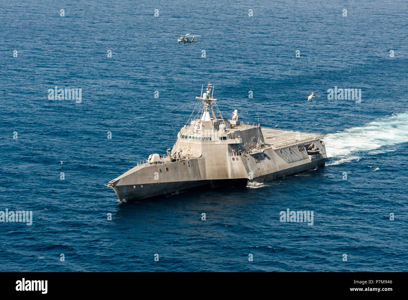 180628-N-BT947-1547 PACIFIC OCEAN (June 28, 2018) - An MQ-8C Fire Scout unmanned helicopter conducts underway operations with an MH-60S Seahawk helicopter and the Independence-variant littoral combat ship USS Coronado (LCS 4). The new Fire Scout variant is expected to deploy with the LCS class to provide reconnaissance, situational awareness, and precision targeting support. Coronado is working with Air Test and Evaluation Squadron 1 (VX-1) to test the newest Fire Scout unmanned helicopter. Coronado is one of four designated test ships in the LCS class assigned to Littoral Combat Ship Squadron Stock Photo