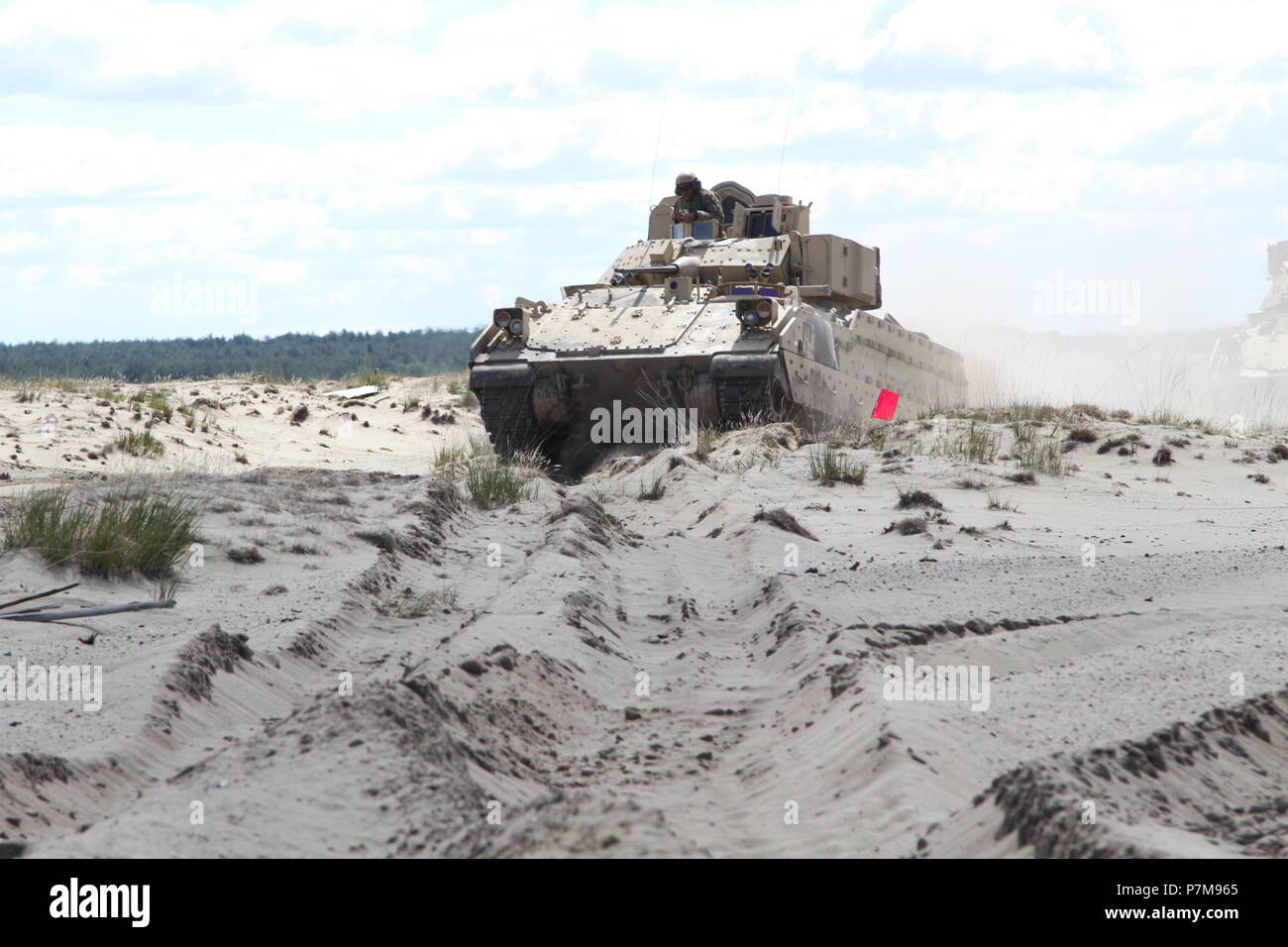 Soldiers assigned to 91st Brigade Engineer Battalion maneuver their Bradley Fighting Vehicle through the sand during the engineer qualification tables in Swietoszow, Poland, on June 30, 2017.  This culminating training event was a preparation event for a company-level combined arms live fire exercise in the near future. The unit is currently deployed in support of Atlantic Resolve in Europe. (U.S. Army National Guard photo by Staff Sgt. Ron Lee, 382nd Public Affairs Detachment, 1ABCT, 1CD/Released) Stock Photo
