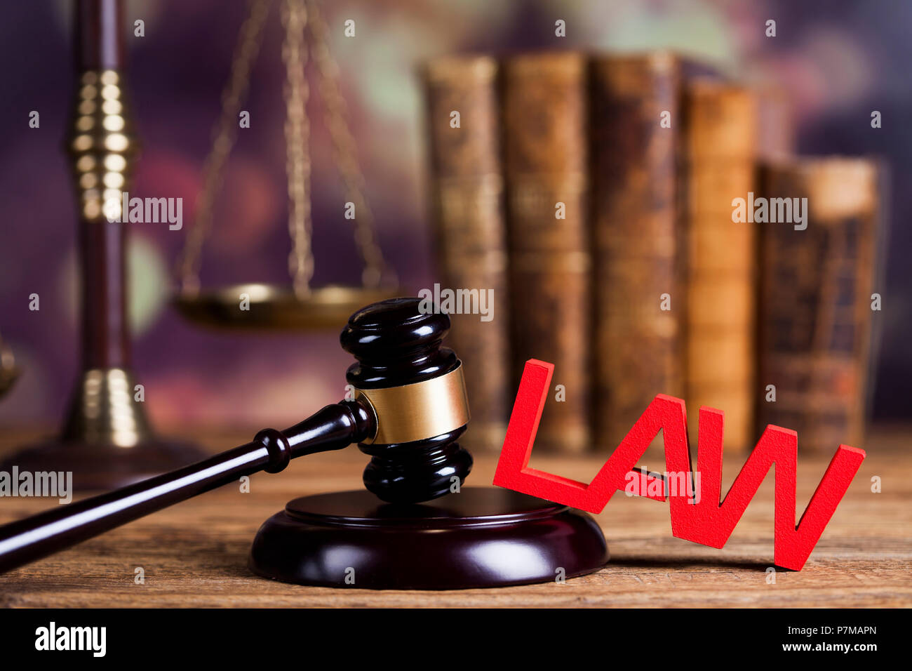 Law theme, mallet of the judge, justice scale, wooden desk background