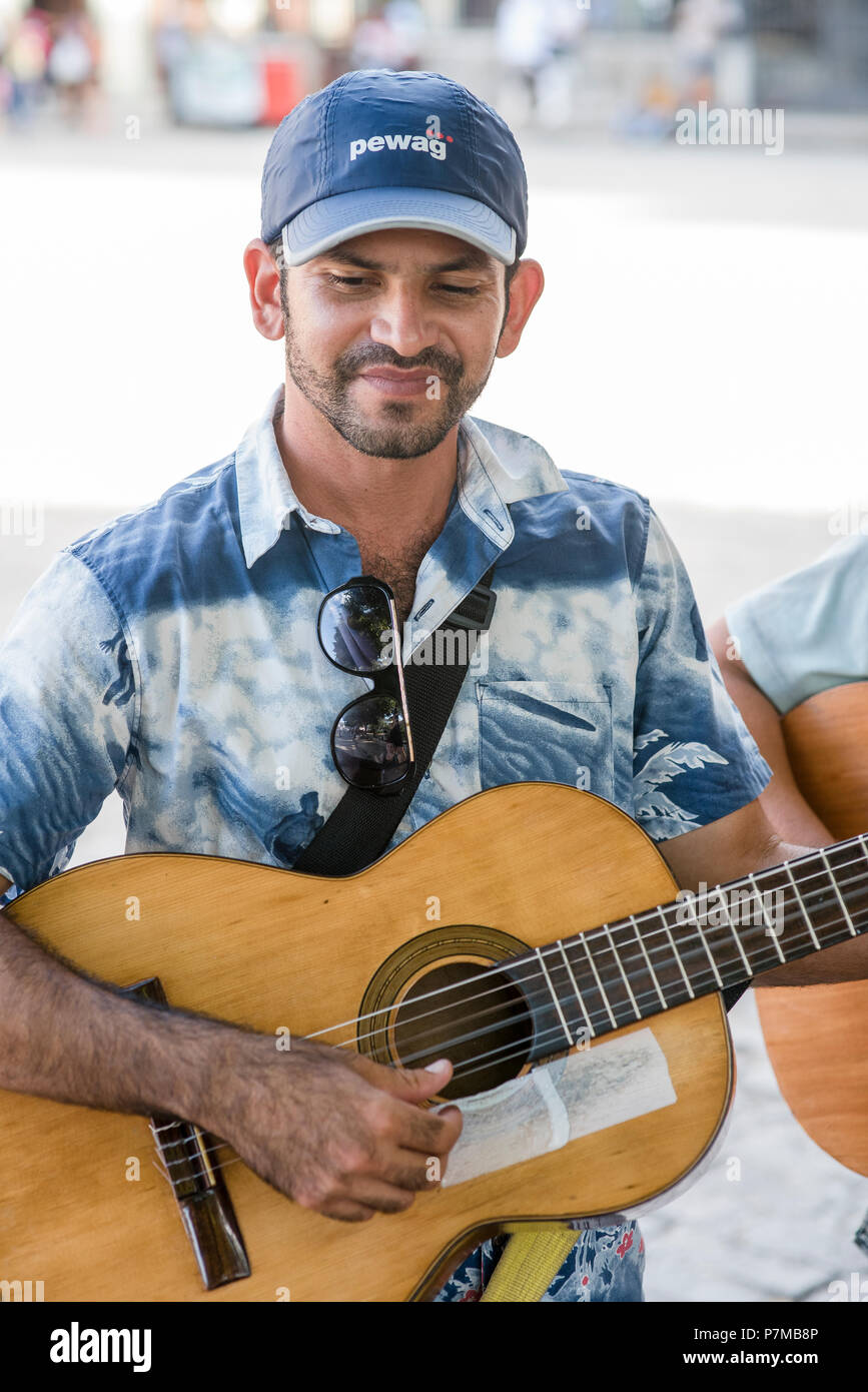 Acoustic guitarists play music for us in a plaza in Havana, Cuba Stock