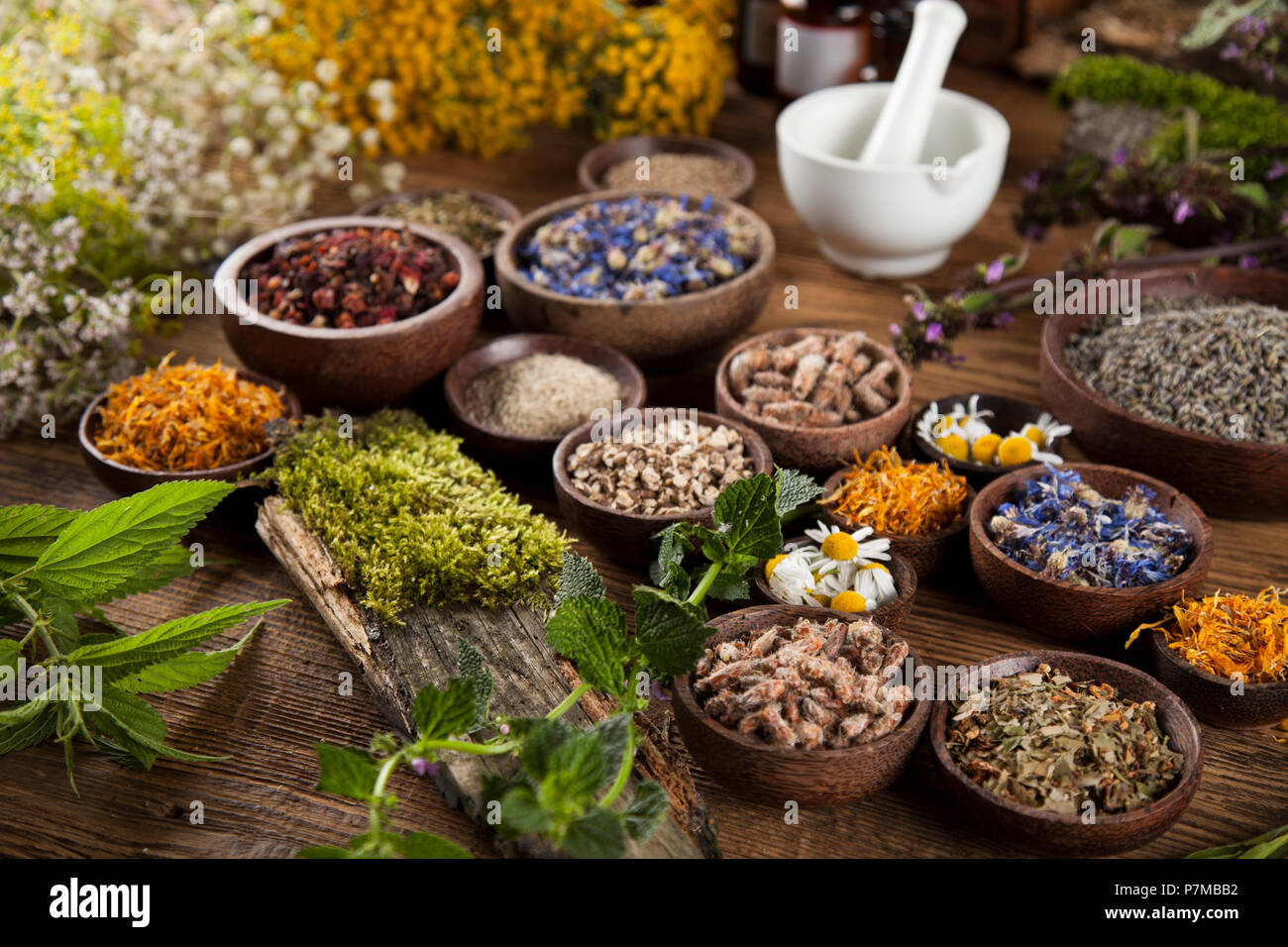 Natural remedy and mortar, healing herbs background Stock Photo - Alamy