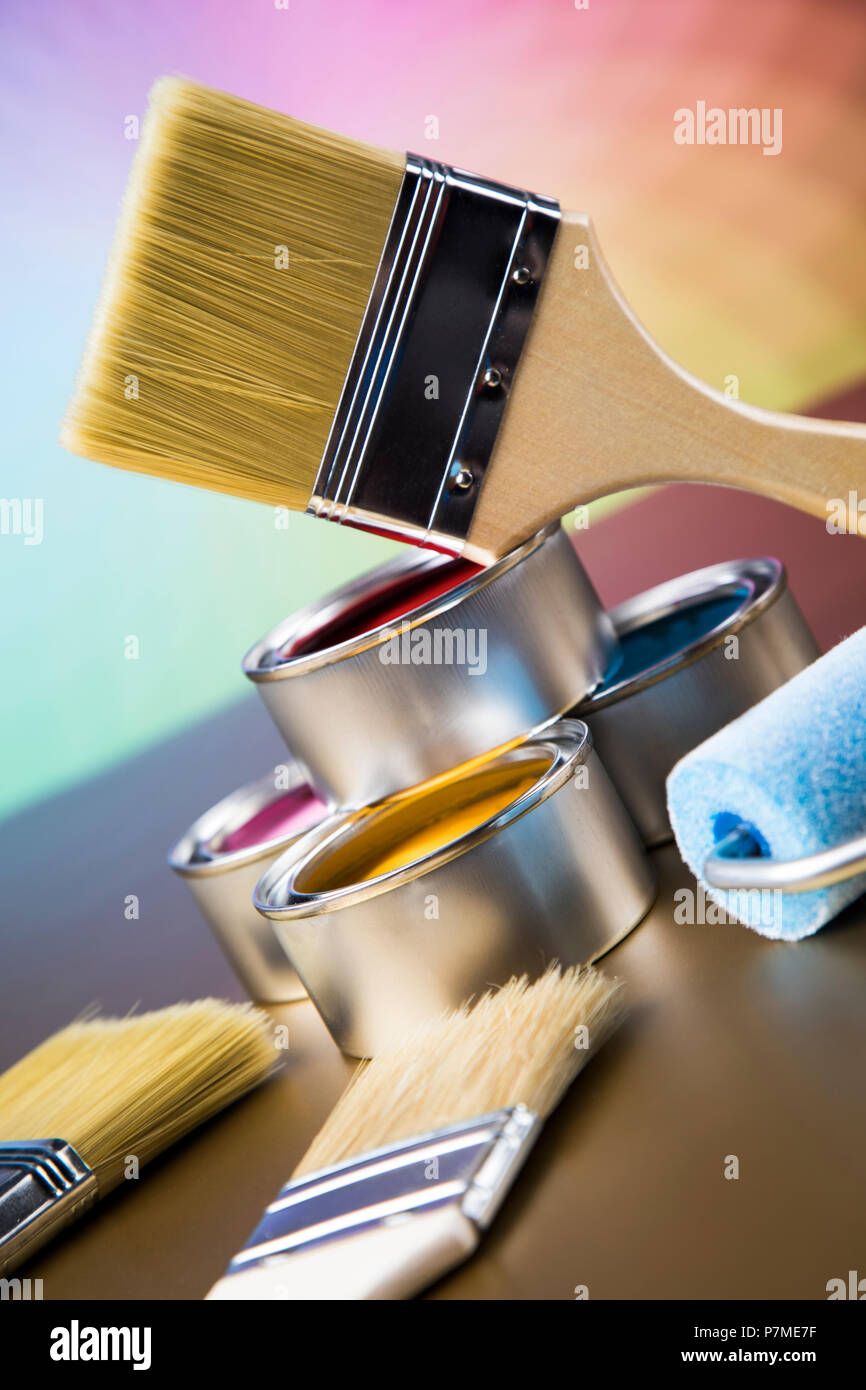 Tin cans with paint, brushes and bright palette of colors Stock Photo