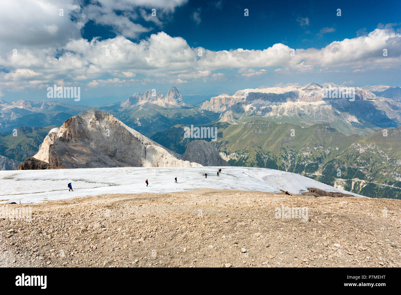 a beautiful landscape from the top of the Marmolada with a group of hikers walking on a glacier, Trento province, Trentino Alto Adige, Italy, Stock Photo