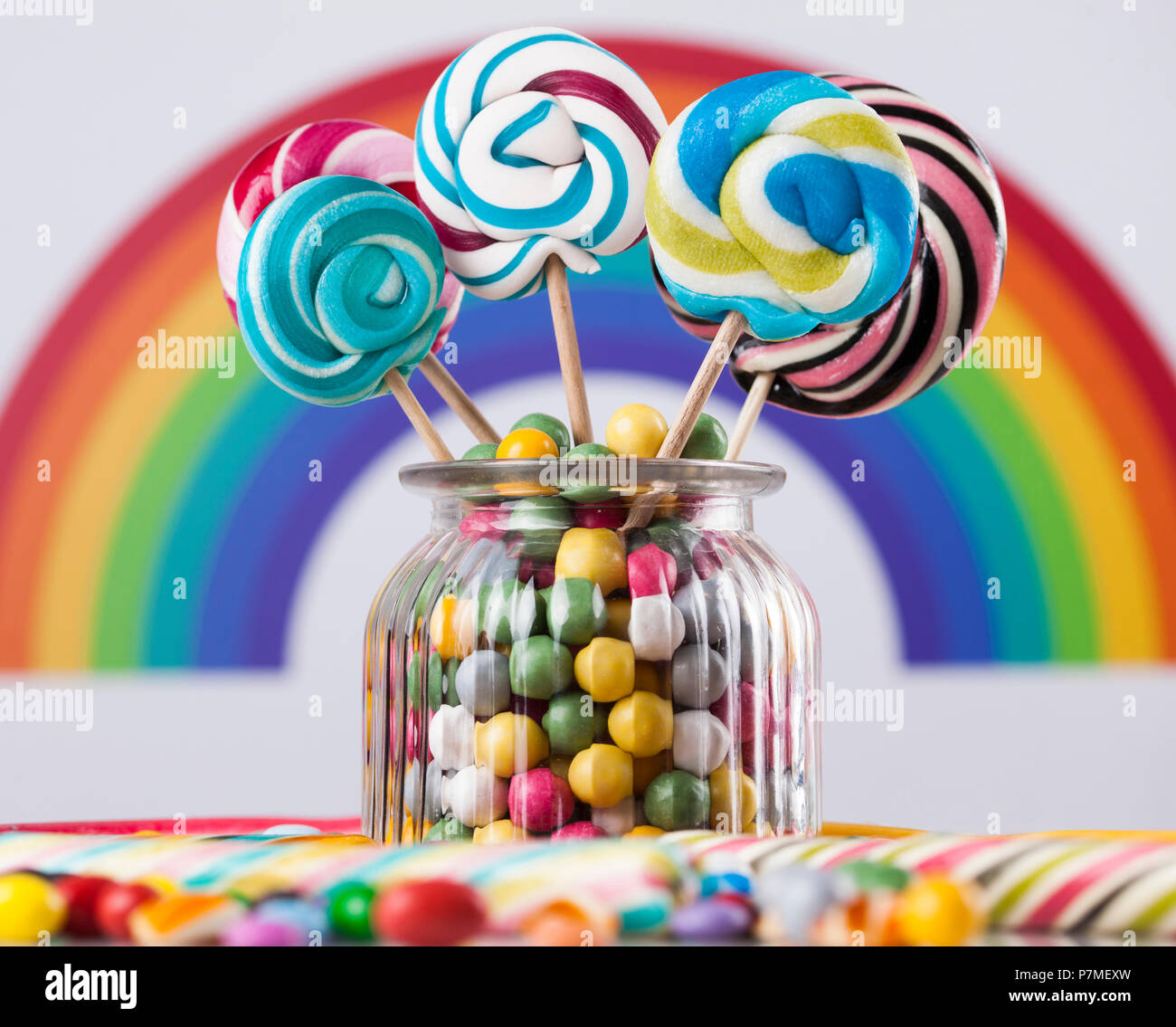 Colorful lollipops and different colored round candy and gum balls ...
