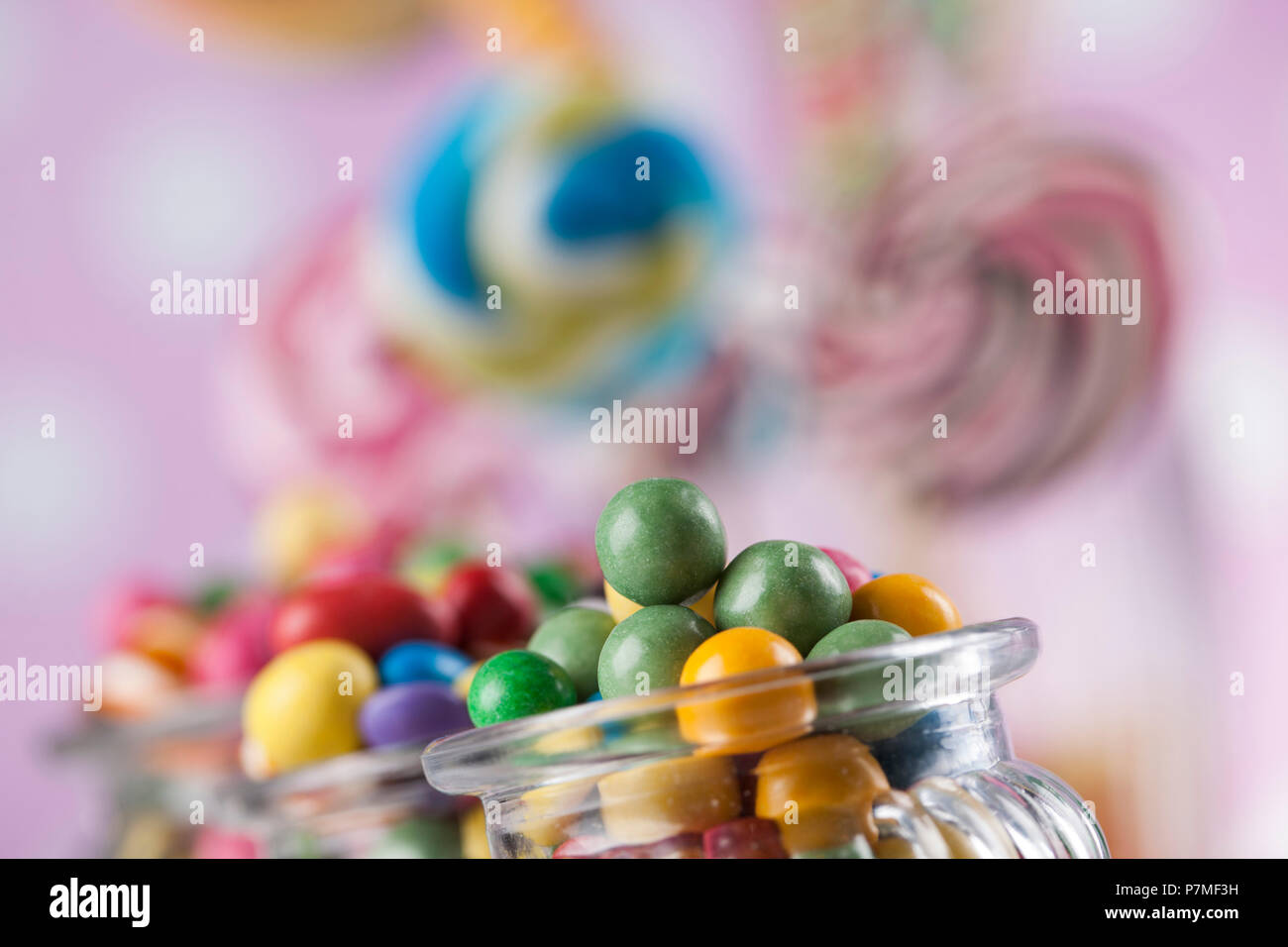 Colorful lollipops and different colored round candy and gum balls ...