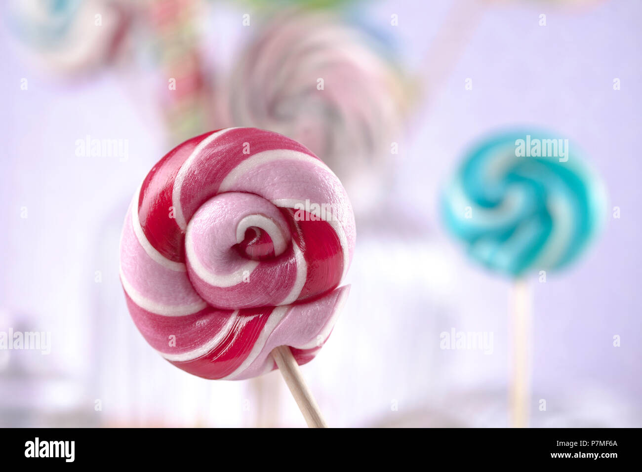 Colorful lollipops and different colored round candy and gum balls ...