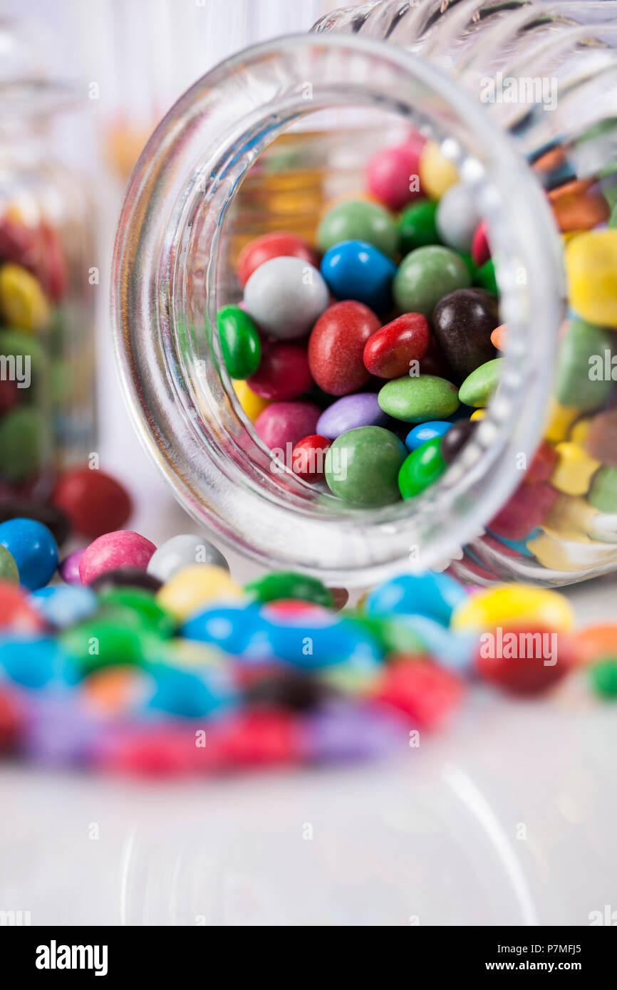 Colorful lollipops and different colored round candy and gum balls ...