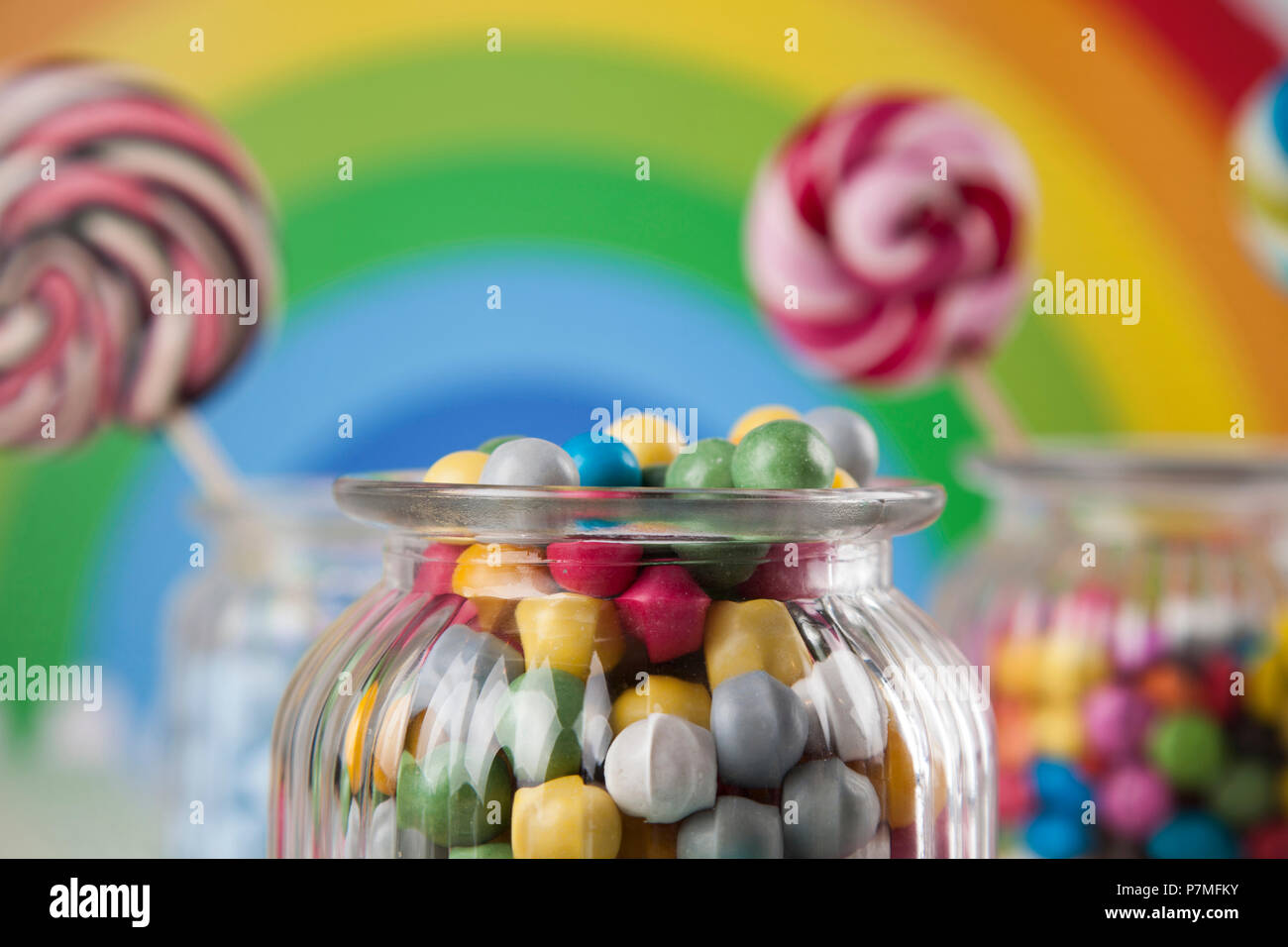 Colorful lollipops and different colored round candy and gum balls ...