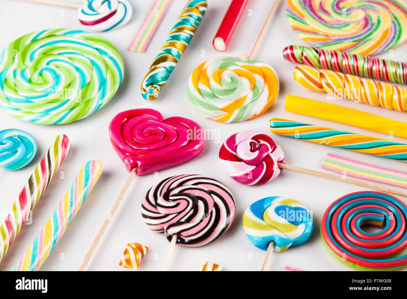 Colorful lollipops and different colored round candy and gum balls ...