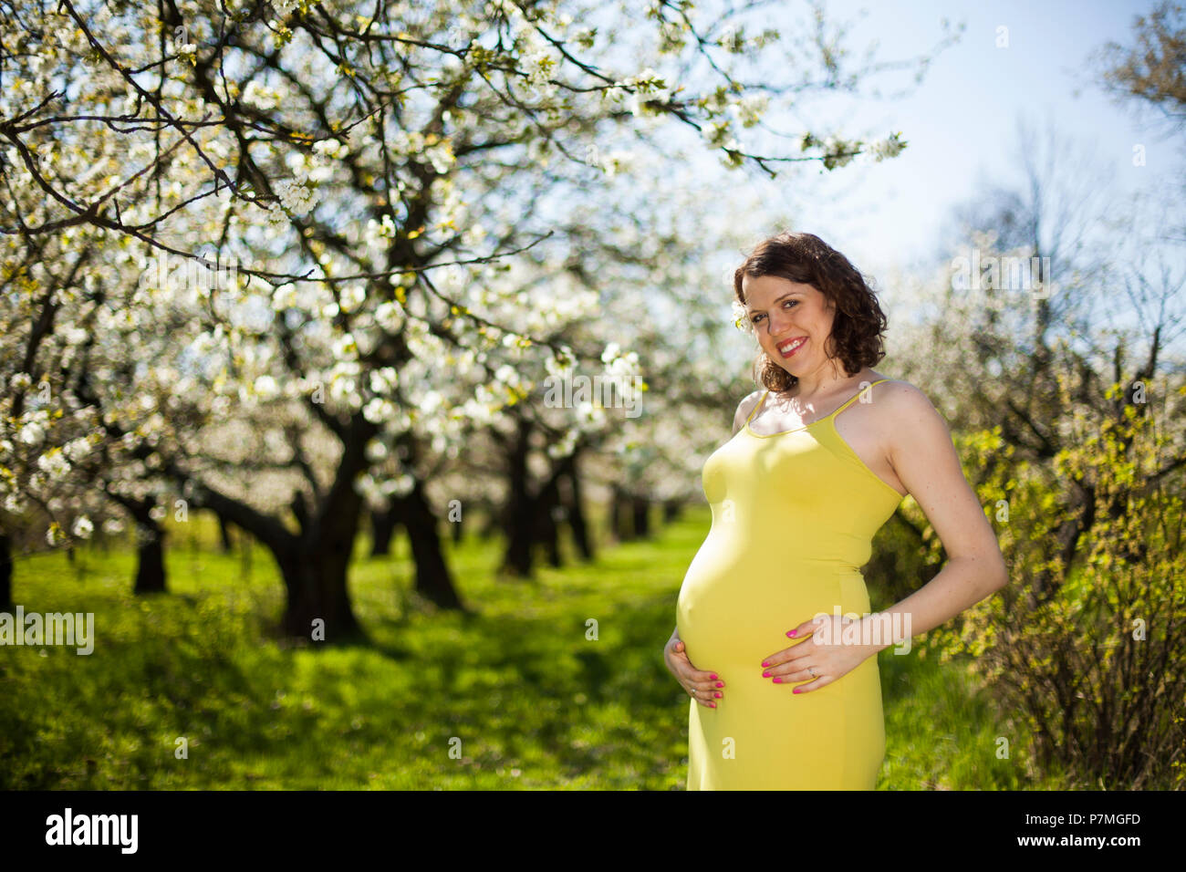 Blooming garden, Beautiful pregnant woman Stock Photo Alamy