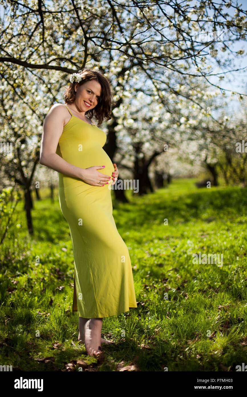 Blooming garden, Beautiful pregnant woman Stock Photo Alamy