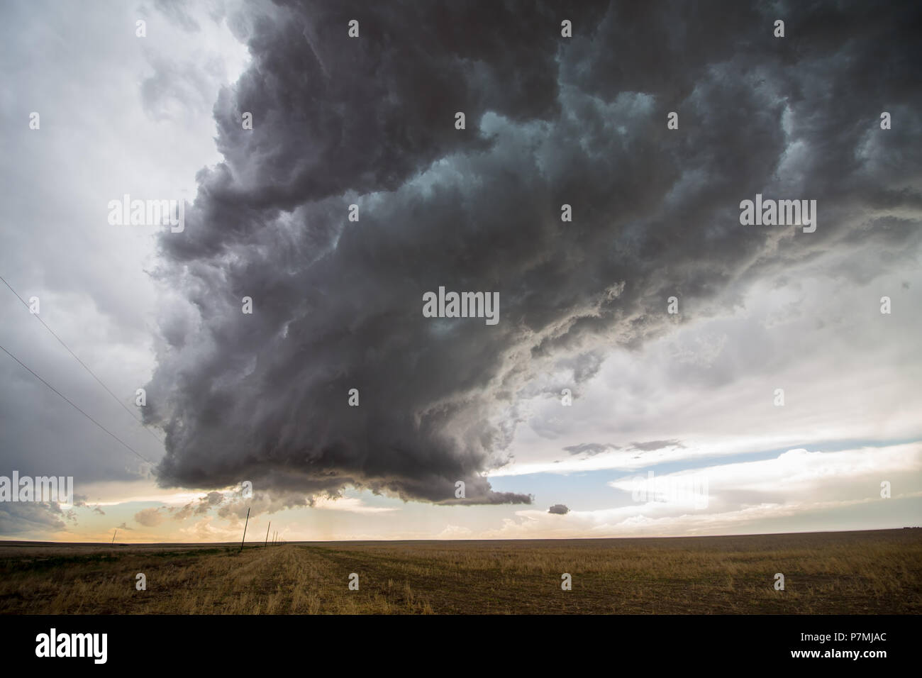 A supercell thunderstorm towers over the landscape of the Great Plains. Stock Photo