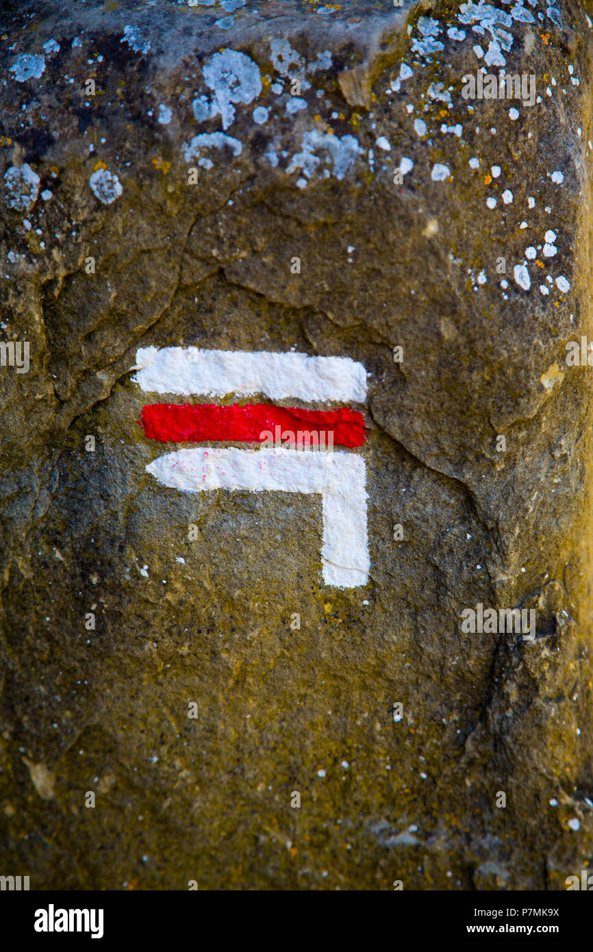 Sign painted on rock showing direction of a walking trail in France Stock Photo